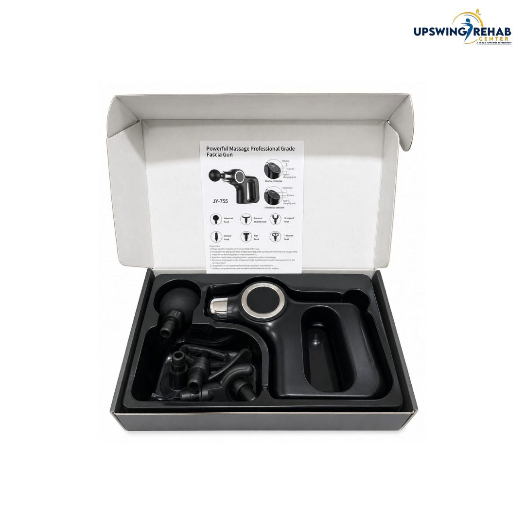 An open white product box displaying a professional-grade massage gun kit with its black foam cover removed, showing included accessories and an instruction insert. The UPSWING REHAB logo is visible in the top right corner.