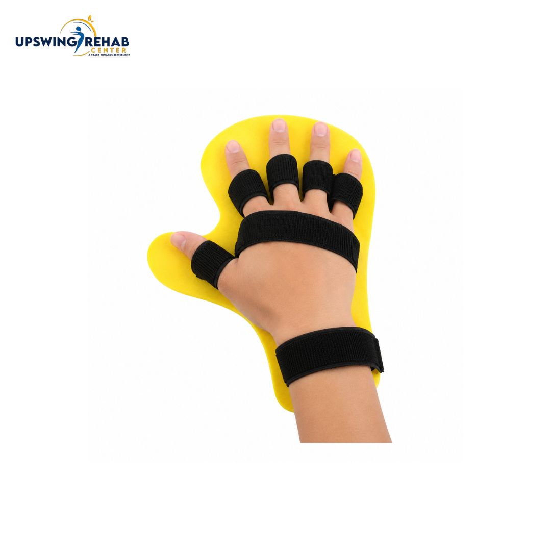 A hand wearing a yellow and black wrist and finger support brace, shown against a plain white background with the Upswing Rehab logo in the top left corner.